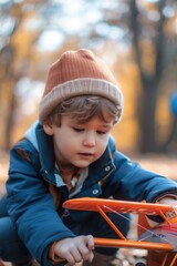 Poster - A young boy having fun playing with a toy airplane. Suitable for children's activities