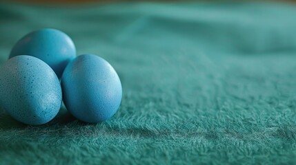Poster - Three blue eggs resting on a vibrant green blanket, perfect for spring or Easter themes