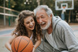 Grandfather and granddaughter laughing with basketball, happy family moments concept.