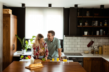 Sticker - Joyful Couple Sharing a Moment Over Breakfast in a Modern Kitchen