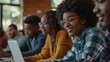 © Usman - African Americans college students and their teacher use laptop during computer class