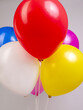 Colorful bright balloons on a stand on a gray background close-up