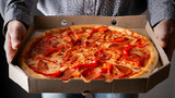 Fototapeta  - Caucasian male hands hold large open carton box with pepperoni pizza front view