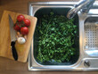 Parsley in a kitchen sink ready to be washed