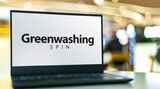 Fototapeta  - Laptop computer displaying the sign of Greenwashing