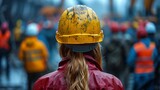 Fototapeta Desenie - Construction worker with a yellow helmet at a workers' assembly