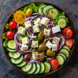A vibrant top-down shot of a Greek salad arranged in a circular pattern, featuring fresh lettuce, tomatoes, cucumbers, red onions, olives, and feta cheese, drizzled with olive oil and sprinkled with o