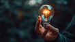 © YuDwi Studio - hand holding light bulb. Business idea concept with innovation and inspiration
