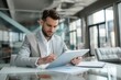 © Andrei - Young business man executive holding pad computer at work.