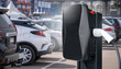 .Electric vehicles charging station on a background of a row of cars. Concept..Electric vehicles charging station on a background of a row of cars. Concept