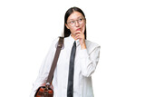 Fototapeta Na drzwi - Young Asian business woman over isolated background having doubts and with confuse face expression