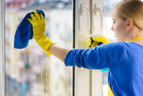 Fototapeta Na sufit - Woman cleaning window at home