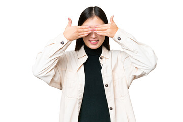 Wall Mural - Young Asian woman over isolated chroma key background covering eyes by hands and smiling