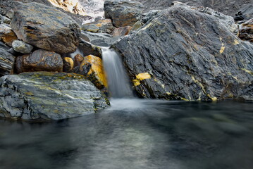 Canvas Print - Russia. The South of Western Siberia, the Altai Mountains. A small waterfall on the Aktru River near the mountain glacier of the same name, filmed on a long exposure.