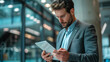 © Alina Tymofieieva - Handsome businessman using tablet in office