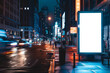 Mockup. Blank white vertical advertising banner billboard stand on the sidewalk at night in front of city street