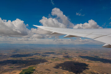 Wall Mural - view of the clouds and airplane wing from the inside, usa