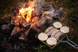 Grilling sausages. Concept of resting in the fresh air, frying sausages on the grill. Sausages, bread, vegetables barbecue