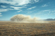 Vast Desert Landscape with Impressive Dust Storm Under Blue Sky