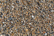 Background texture of small and broken pieces of seashells and beach sand, coastal resort or retirement creative copy space, horizontal aspect