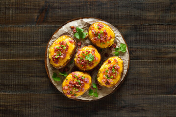 Wall Mural - Baked stuffed potatoes with bacon, green onion and cheddar cheese