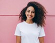 Attractive girl with curly hair wearing blank white t-shirt on pink background. Mockup for tshirt print design