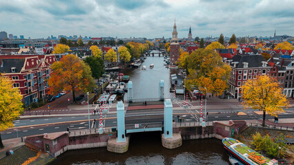 Aerial drone view Amsterdam autumn cityscape narrow old houses, canals, boats bird's eye view