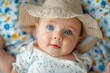 An adorable baby with striking blue eyes wears a cute straw hat and gazes upwards with curiosity