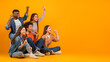 © Prostock-studio - Group of friends cheering and celebrating on orange background
