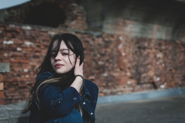 A young girl walks in the park near the old fortress