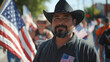 Brown bearded man wearing a black cowboy hat at a Labor Day celebration in the United States
