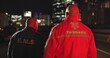 Back, man and paramedic walking to ambulance for emergency, ems service and healthcare in city. Rear view, medical professional and doctor outdoor at night for first aid, rescue operation and work