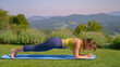 Sporty woman doing strenuous plank pose at yoga practice to build core strength