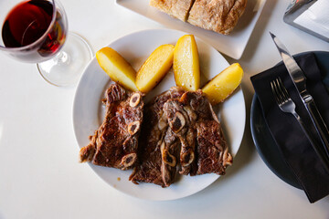 Wall Mural - Appetizing deep-fried veal on bones with potato served on plate