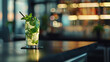 Mojito cocktail with mint leaves on a bar counter