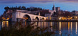 View of four surviving arches of Pont St-Benezet and Avignon Cathedral at sunset, France