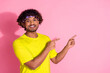 Photo of satisfied cheerful man wear trendy yellow clothes demonstrate empty space isolated on pink color background
