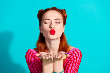 Wall Mural - Photo of cute dreamy lady dressed pink knitted shirt sending you arms kiss isolated blue color background