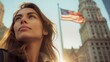 Latin woman looking at the horizon with the US flag in the background in the city. Happy latin woman contemplating the landscape full of hope for the future.