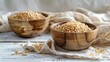 Two wooden bowls with unpolished brown rice on a white wooden background and linen textile. Side view, close up, selective focus.