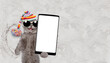 Happy cat wearing warm knitted hat with pompon making snow angel while lying on snow and holding smartphone with white blank screen in it paw. Empty space for text