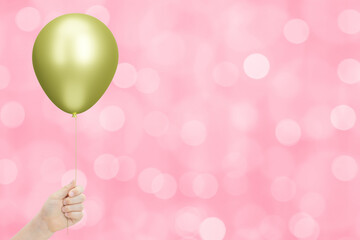 Aufkleber - Сhild's hand holding the yellow or golden balloon on blurred pink background. Empty space for text