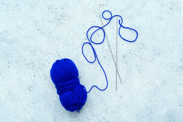 Sticker - Yarn ball and knitting needles on blue grunge background