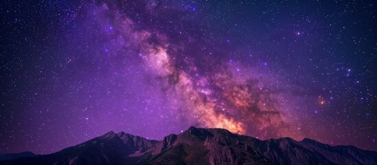 Wall Mural - Silent night with a dark sky filled with glowing stars and the milky way stretching above a majestic mountain peak
