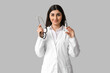 © Pixel-Shot - Beautiful young female doctor with syringe and stethoscope on white background