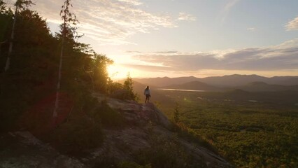 Wall Mural - Drone Epic Female Photographer Walks to Sunset Mountain Edge Autumn Fall Colors