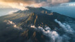 aerial view of a mountain in the clouds at sunrise