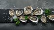 Fresh oysters on a black stone with sea salt and parsley garnish.