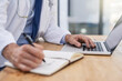 © peopleimages.com - Doctor, writing and hands of notes with data and medical research for pharmaceutical study in office. Person, tech and report information in notebook with hospital paper of healthcare worker