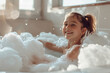 cute little girl sitting in bath with foam